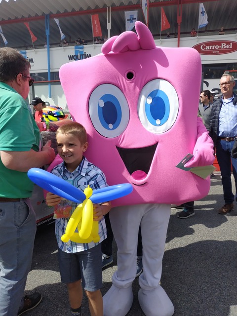 Yolloh mascot with a child at an event